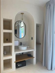 a bathroom with a sink and a mirror at Casa Hood By the Sea in Holbox Island