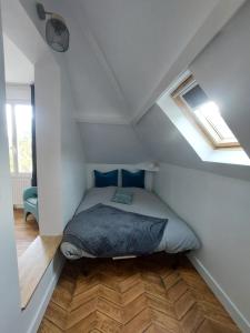 a bedroom with a bed in a attic at "Ô Tour's Angels" A Côté in Tours +26 photos