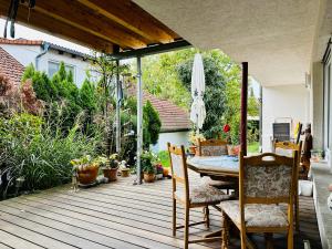 a patio with a table and chairs on a deck at 2,5-Zimmerwohnung mit Terrasse - KEINE Monteure in Marbach am Neckar