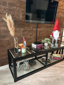 a santa claus sitting on a table with a television at Przestronna i jasna kawalerka z balkonem in Wrocław +4 photos