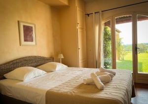 a bedroom with a bed with two towels on it at La Villa La Source à Aix en Provence in Aix-en-Provence +40 photos