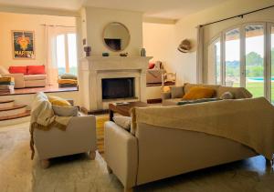 a living room with two couches and a fireplace at La Villa La Source à Aix en Provence in Aix-en-Provence
