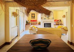a living room with a table with a bowl on it at La Villa La Source à Aix en Provence in Aix-en-Provence
