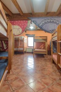 a room with bunk beds and a tiled floor at Conjunto Rural la Tejedora. Albergue y estudios familiares. in Rasines