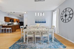 een eetkamer en een keuken met een witte tafel en stoelen bij Exquisitely Designed Townhome - JZ Vacation Rentals in Saint Louis