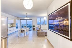 Pool Penthouse-Hosted by Sweetstay في Is-Swieqi: مطبخ وغرفة طعام مع طاولة طعام في المنزل