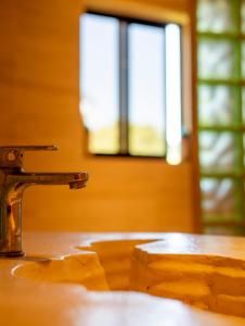 a close up of a sink with a window at Hush Maderas in San Juan del Sur