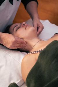 uma mulher deitada numa cama a receber uma massagem em HOSTAL CRUZ CHICA em La Cumbre