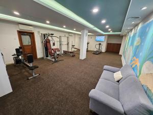 a living room with a couch and gym equipment at Holiday Home in Komarna
