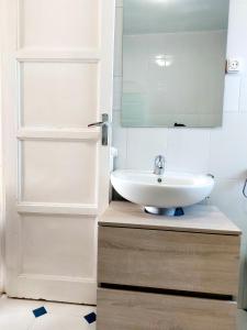 a bathroom with a sink and a mirror at La casita de Soria in Soria