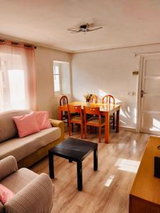 a living room with a couch and a table at La casita de Soria in Soria