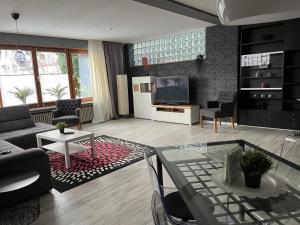 a living room with a couch and a tv at Best Apartments in Bad Salzuflen