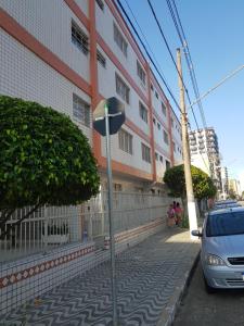 een auto geparkeerd in een straat naast een gebouw bij Apartamento Perto da Praia in Praia Grande