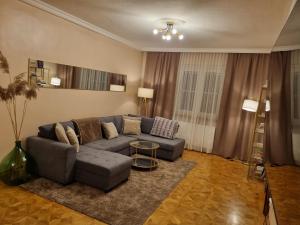 a living room with a couch and a table at Villa with private Sauna and Jacuzzi, 8 min from Schloss Schöbrunn in Vienna