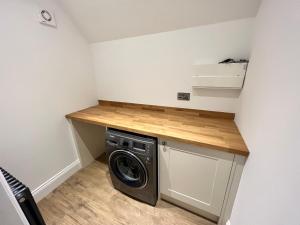 a laundry room with a washer and dryer at The Hayloft in Sudbrooke