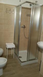 y baño con ducha, aseo y lavamanos. en Pietra di Bismantova Short Lets, en Castelnovo neʼ Monti