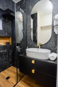 a bathroom with a sink and a mirror at Hi-lux Ultracentral - 4BR Superior - Amazing View in Bucharest +37 photos