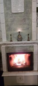 a fireplace with a fire inside of it at Ventspils apartamenti pie Rātslaukuma in Ventspils