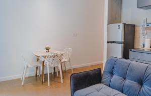 a living room with a table and a refrigerator at Peace Lofts and Apartments in Santa Teresa Beach +43 photos