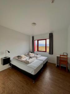 Voodi või voodid majutusasutuse Guesthouse Nypugardar toas