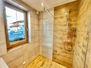 a bathroom with a shower and a window at Appartement Mama in Haus im Ennstal