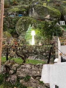 a painting of a white figure on a rock at A Casa da Rapariga de Cabelo Azul in Manteigas