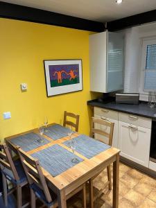 a kitchen with a wooden table with wine glasses on it at Bungalow Nordschwarzwald im Ferienpark Schellbronn in Neuhausen