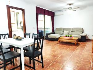 a living room with a table and a couch at Villa Brisita in Granadilla de Abona
