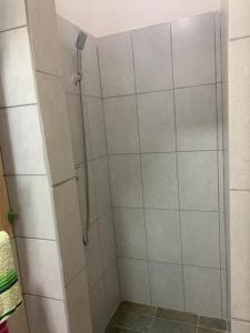 a shower with a glass door in a bathroom at Smjestaj in Doboj