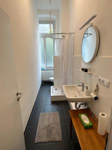 a bathroom with a sink and a mirror at urban-studios-cologne I studio in Cologne +42 photos