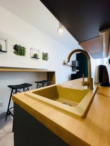 a kitchen with a yellow sink and a counter at Apartmán Twins Green blízko centra in Michalovce