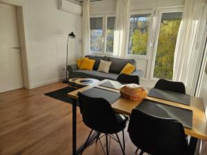 a living room with a table and a couch at Land Apartments in Zagreb