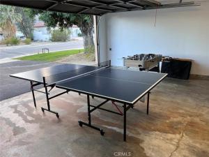 a ping pong table sitting inside of a garage at Sundance Villas by Private Villa Management in Palm Springs