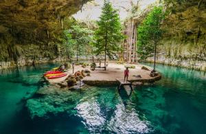 a group of people standing in the water in a cave at Casa Sílice Guesthouse in Valladolid
