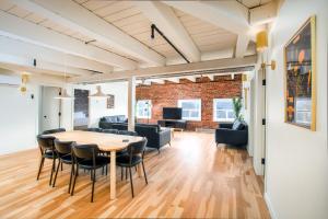 a dining room and living room with a table and chairs at Les Lofts de la Barricade - Par les Lofts Vieux-Québec in Quebec City