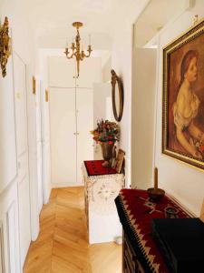 a room with a painting on the wall and a table at Parisian style Appartment Private room with Shared bathroom near Bastille and Gare de Lyon in Paris