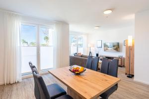 a living room with a wooden table and chairs at Apartment "Inselglück" - Haffresidenz in Garz