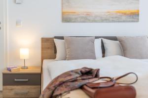 a bedroom with a bed with a pair of glasses on it at Apartment "Inselglück" - Haffresidenz in Garz +25 photos