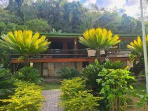 a house with palm trees in front of it at Private Holiday Home Malolo Island in Nadi