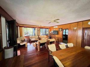 a living room with a table and a dining room at Private Holiday Home Malolo Island in Nadi