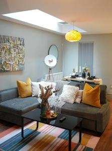 a living room with a couch and a table at Stunning Brighton Seaside 2-Bedroom Townhouse with Patio, Sleeps 6 in Brighton & Hove