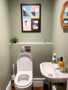 a bathroom with a toilet and a sink at Stunning Brighton Seaside 2-Bedroom Townhouse with Patio, Sleeps 6 in Brighton & Hove
