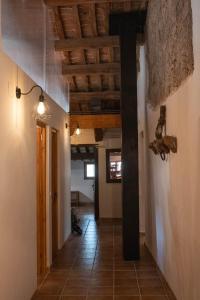 a hallway of a house with a wooden ceiling at Mas el Cornut in Campdevánol