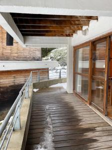 a wooden walkway leading up to a building at Appartement Chamrousse, 4 personnes - Village du Bachat in Chamrousse