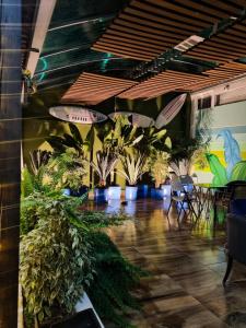a room with potted plants and tables and chairs at Florentina in Tunja +22 photos