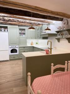 a kitchen with white cabinets and a counter top at El rincón de la Yaya in Pampaneira