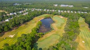 an aerial view of a golf course with a pond at The Inn at LBI National Golf & Resort in Little Egg Harbor Township