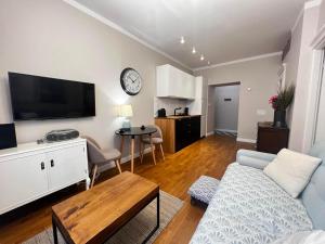 a living room with a couch and a flat screen tv at Centrum Apartamenty Stare Miasto in Kraków