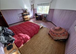 a bedroom with a large red bed and a window at Casa Agni in Treinta y Tres