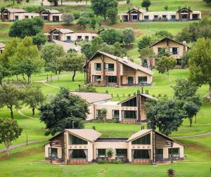 a large house in the middle of a green field at aha Alpine Heath Resort in Bergville